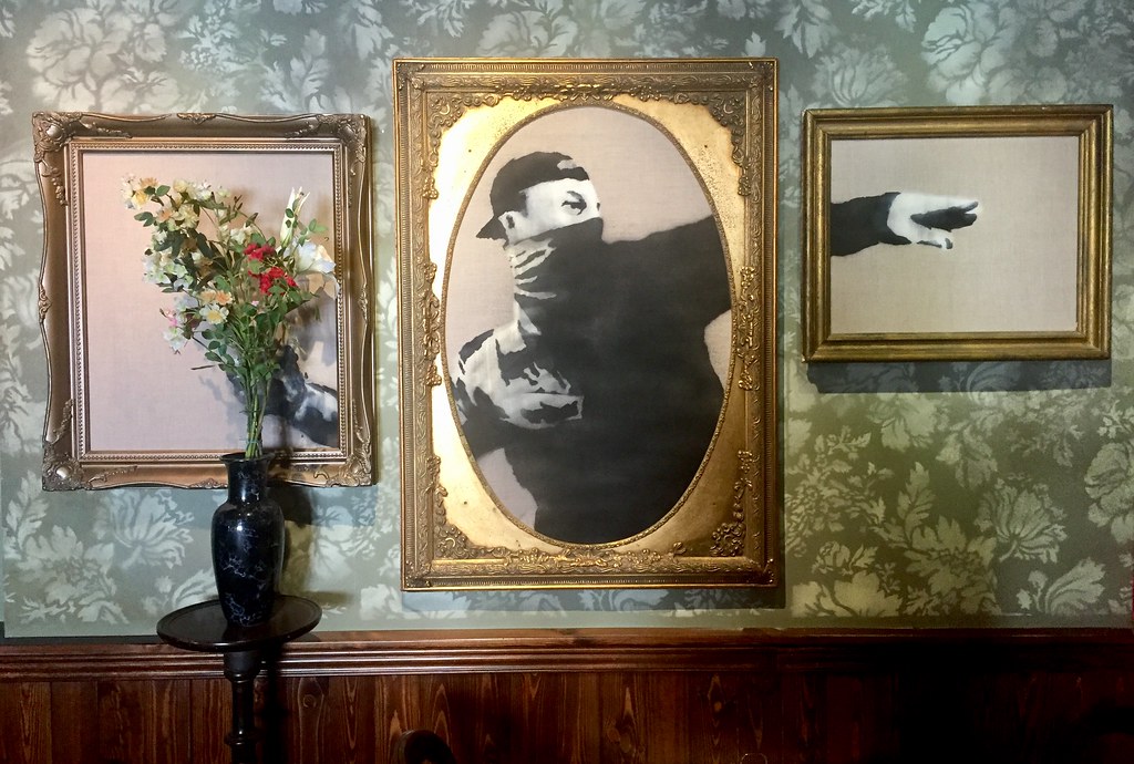 Banksy's Walled Off Hotel lobby, Bethlehem — featuring Banksy artworks and political commentary throughout.