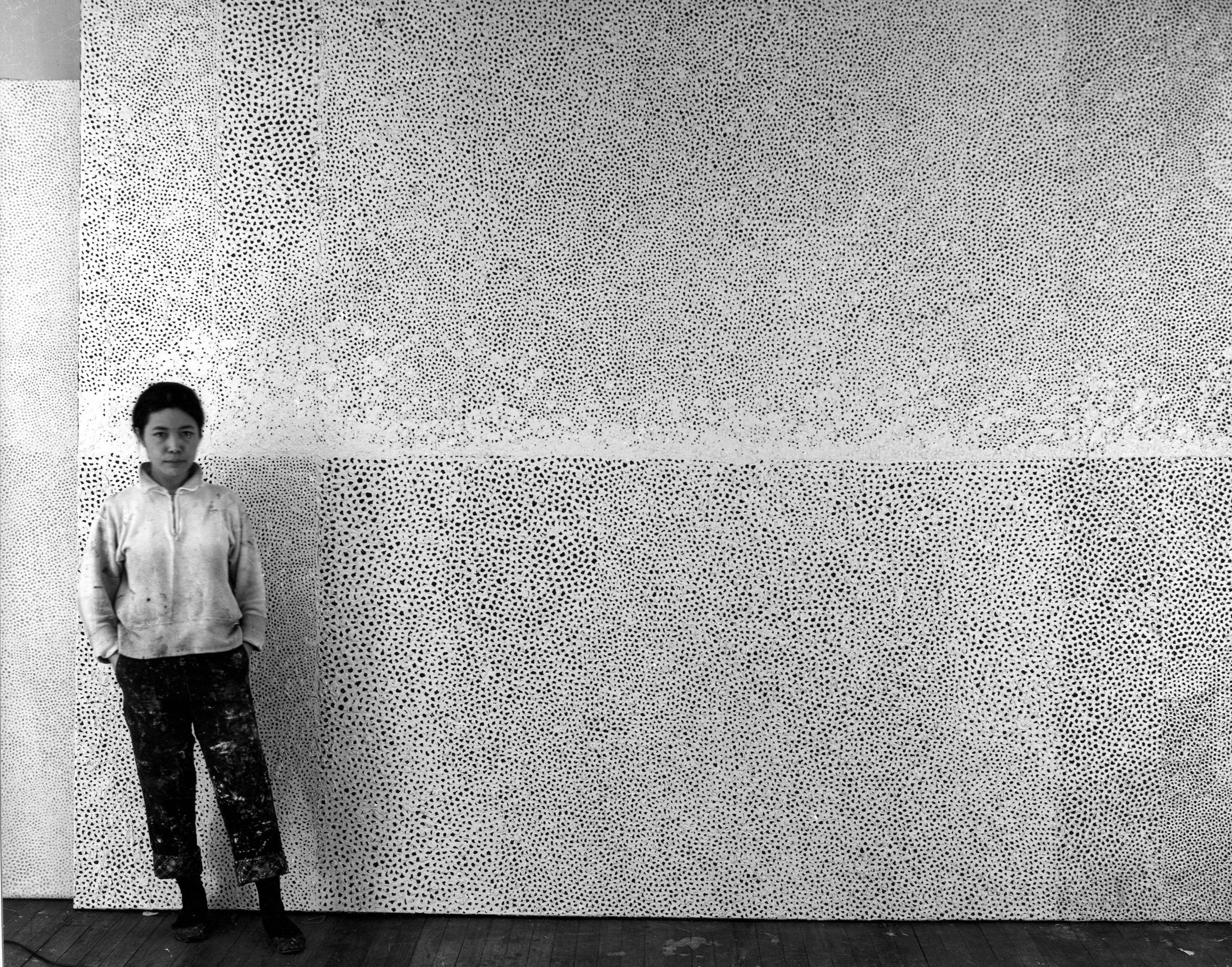 Kusama in front of her 10-metre-long Infinity Net painting